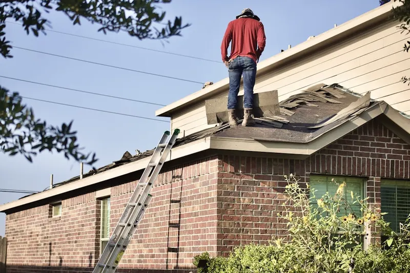 Professional roofer working on a residential roof in Brookneil